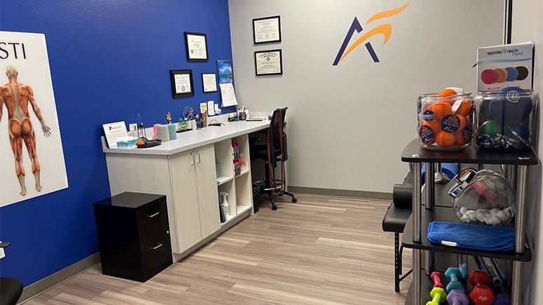 A look inside the recovery room at Airrosti Brownsville, showing exercise mats and stretching and physical therapy accessories in the background.