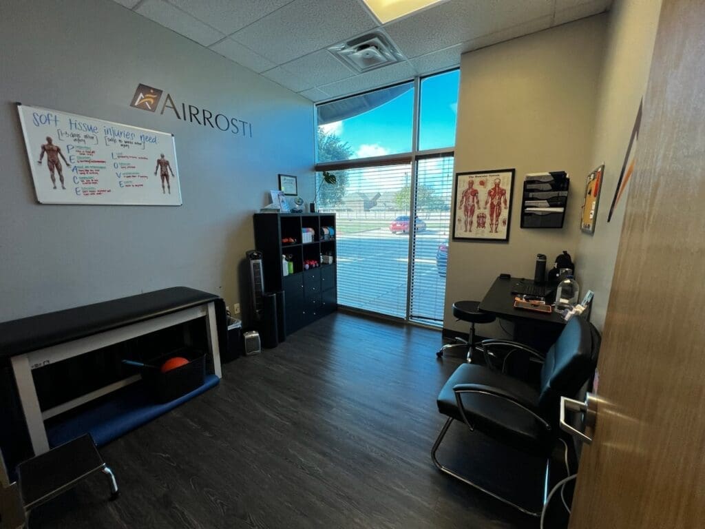a photo of the recovery room at Airrosti Rowlett. Exercise balls, table and mats visible.