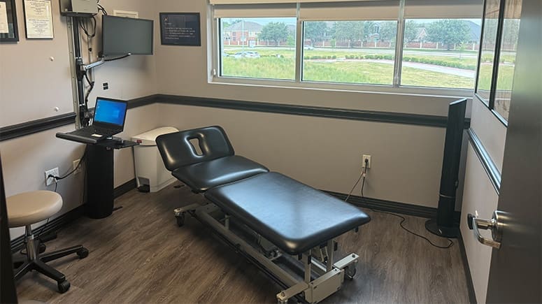 an interior photo of the treatment room at South Grand Prairie. Treatment table is visible.