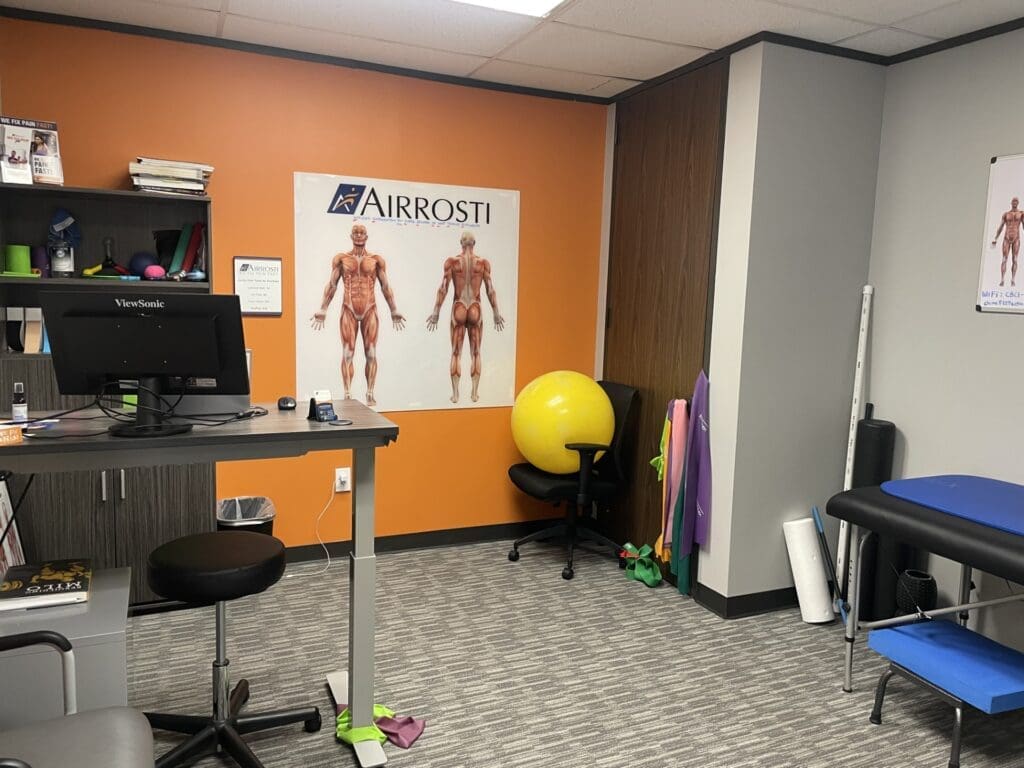 Photo of the recovery room at Airrosti The Woodlands. Exercise ball, exercise bands, and the MSK diagram on the wall.