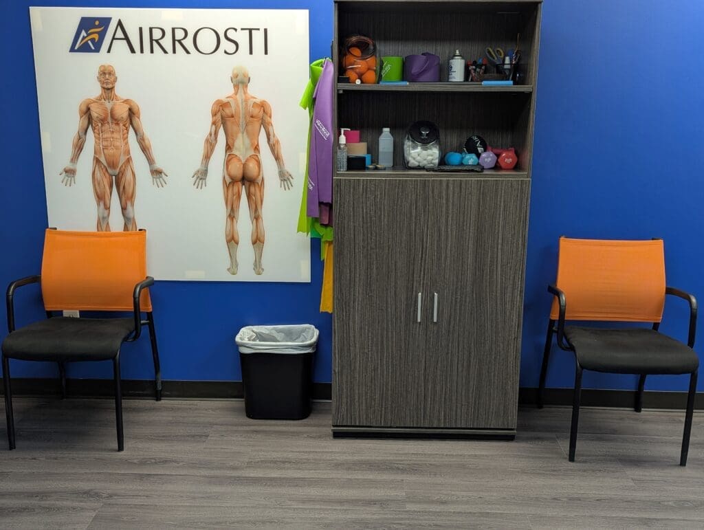 Recovery room at Airrosti Tomball. Ktape and MSK diagram poster are featured.